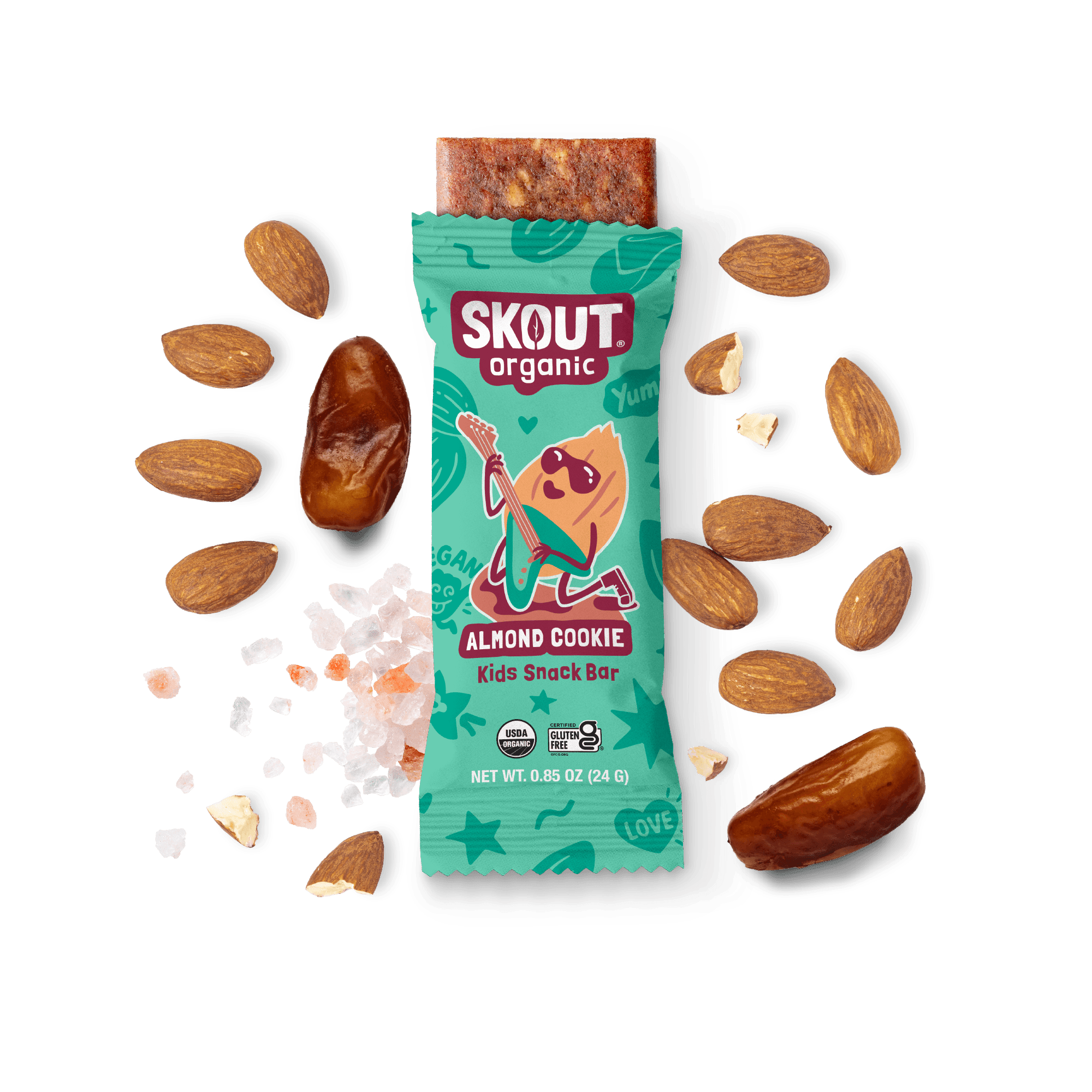 Skout Organic Almond Cookie Kids Snack Bar in an open wrapper, surrounded by dates, almonds, and Himalayan pink salt.