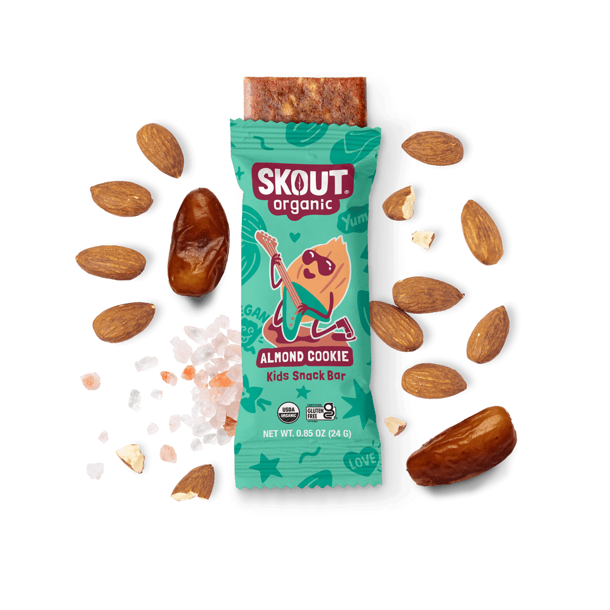 Skout Organic Almond Cookie Kids Snack Bar in an open wrapper, surrounded by dates, almonds, and Himalayan pink salt.