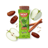 Skout Organic Apple Pie Kids Snack Bar in an open wrapper, surrounded by dates, apples, and cinnamon sticks.