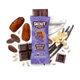 Skout Organic Chocolate Brownie Kids Snack Bar in an open wrapper, surrounded by dates, coconut, cocoa, and vanilla.