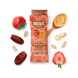 Skout Organic Peanut Butter & Jelly Kids Snack Bar with open wrapper and bar showing, surrounded by dates, peanuts, and strawberries