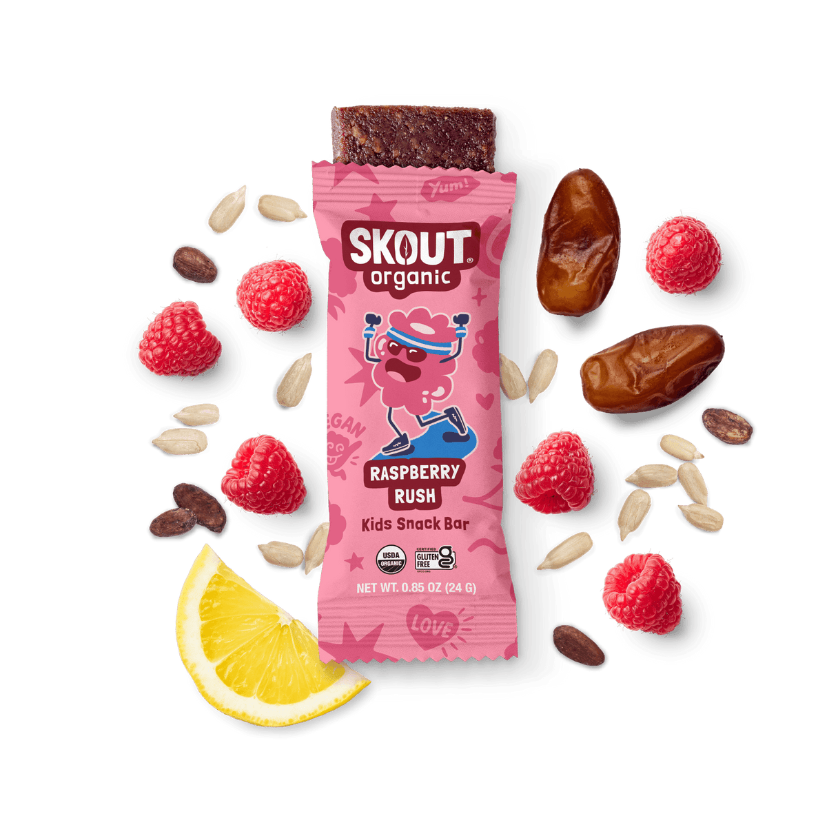 Skout Organic Raspberry Rush Kids Snack Bar in an open wrapper, surrounded by dates, raspberries, and a lemon wedge.