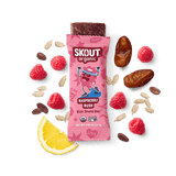 Skout Organic Raspberry Rush Kids Snack Bar in an open wrapper, surrounded by dates, raspberries, and a lemon wedge.