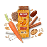 Skout Organic Small Batch Carrot Cake Kids Snack Bar with open wrapper and bar showing, surrounded by dates, carrots, walnuts, and cinnamon sticks