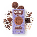 Skout Organic Double Chocolate Soft-Baked Cookies in an open box, surrounded by cocoa powder and chocolate chips.