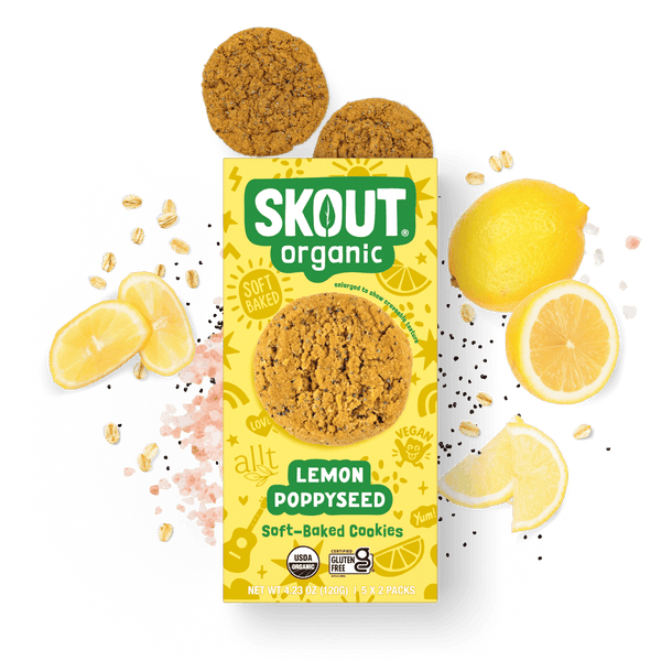 Skout Organic Lemon Poppyseed Soft-Baked Cookies in an open box, surrounded by lemon slices and poppy seeds.
