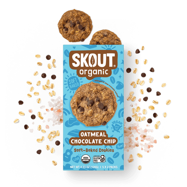 Skout Organic Oatmeal Chocolate Chip Soft-Baked Cookies in an open box, surrounded by oats and chocolate chips.