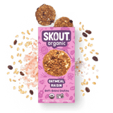 Skout Organic Oatmeal Raisin Soft-Baked Cookies in an open box, surrounded by oats and raisins.