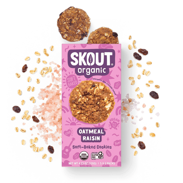 Skout Organic Oatmeal Raisin Soft-Baked Cookies in an open box, surrounded by oats and raisins.