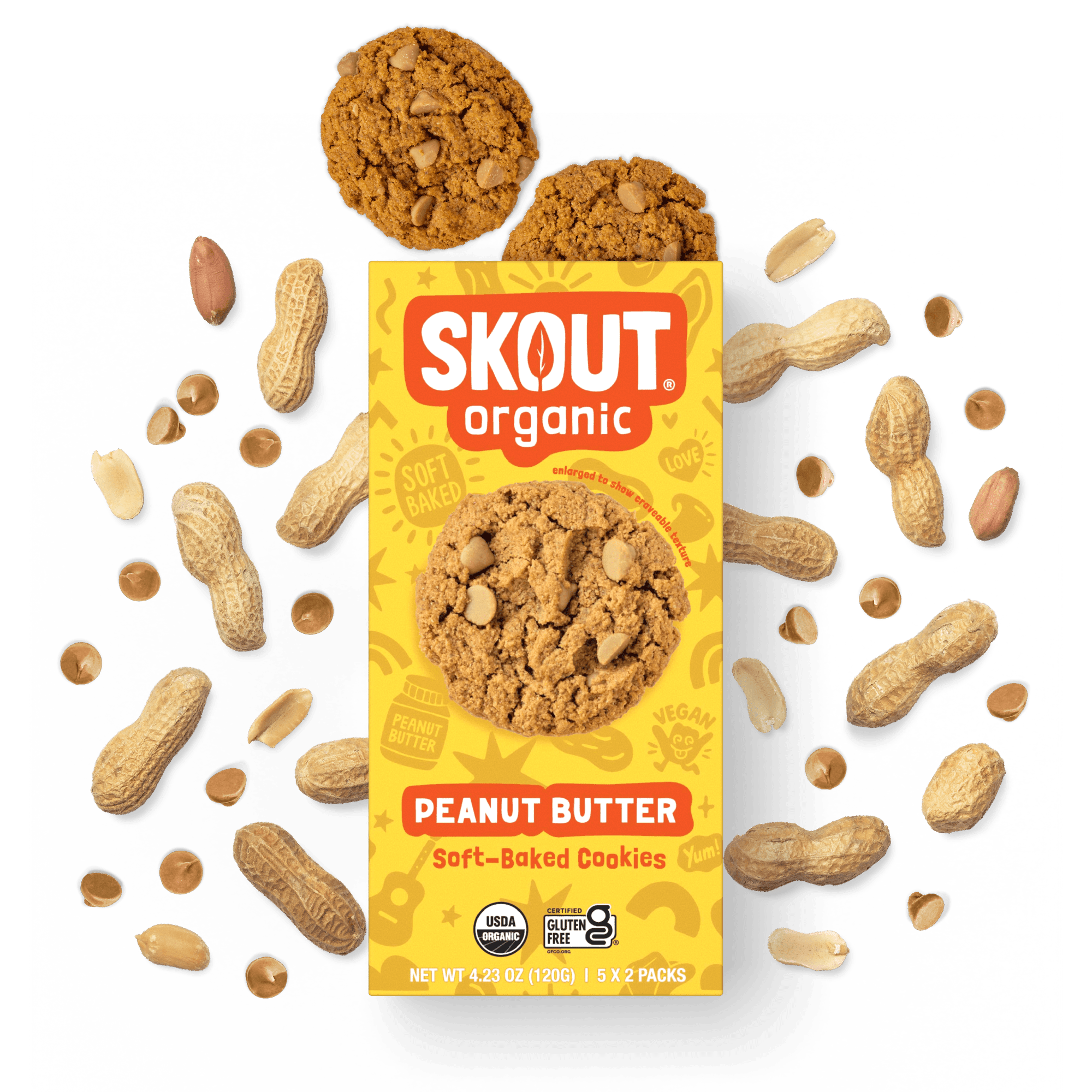 Skout Organic Peanut Butter Soft-Baked Cookies in an open box, surrounded by peanuts and peanut butter chips.