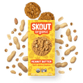Skout Organic Peanut Butter Soft-Baked Cookies in an open box, surrounded by peanuts and peanut butter chips.