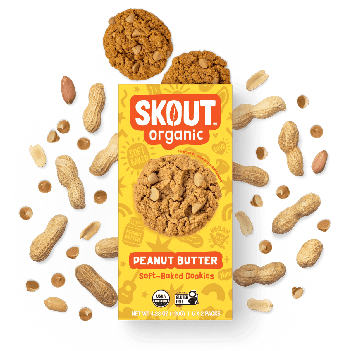 Skout Organic Peanut Butter Soft-Baked Cookies in an open box, surrounded by peanuts and peanut butter chips.