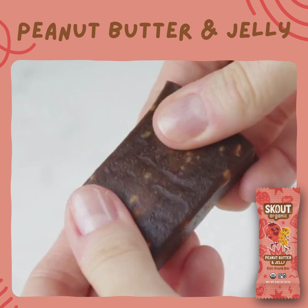 Close-up of a Peanut Butter & Jelly Kids Snack Bar being pulled apart to show its soft, chewy interior with peanut pieces.