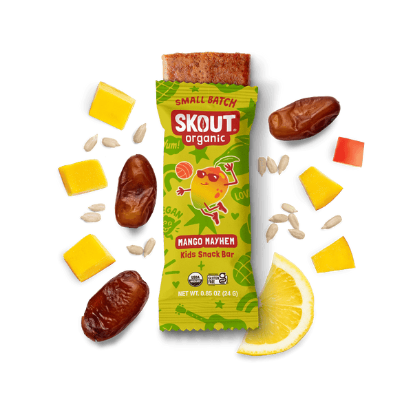 Skout Organic Small Batch Mango Mayhem Kids Snack Bar with open wrapper and bar showing, surrounded by dates, mango, sunflower seeds, and lemon